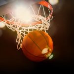 basketball sinking through the net