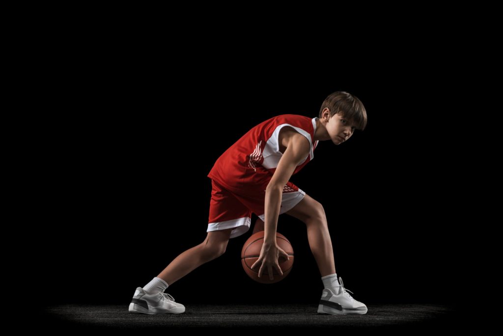 young man dribbling basketball